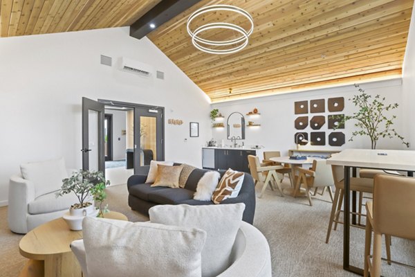 Elegant clubhouse with modern furnishings at Hudson West Apartments, ideal for social gatherings and community events
