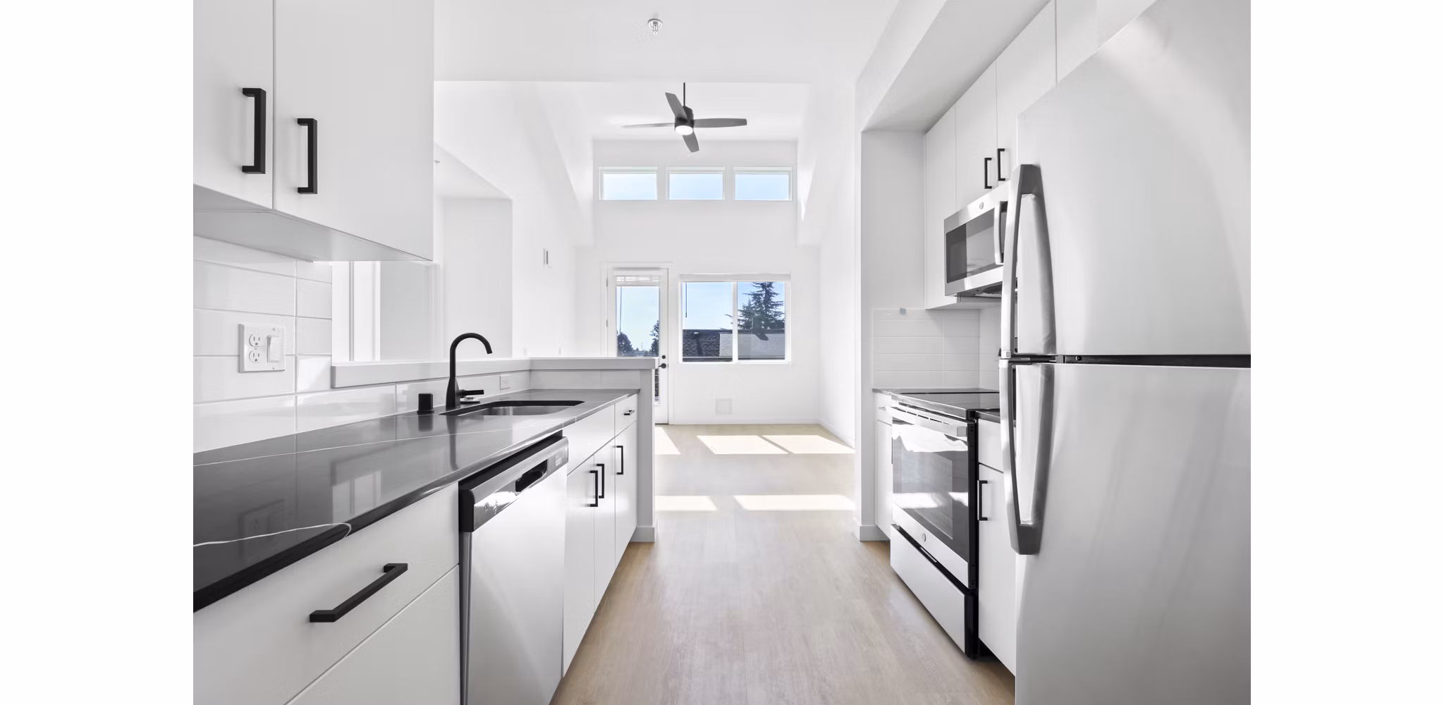 Modern kitchen with stainless steel appliances at Hudson West Apartments