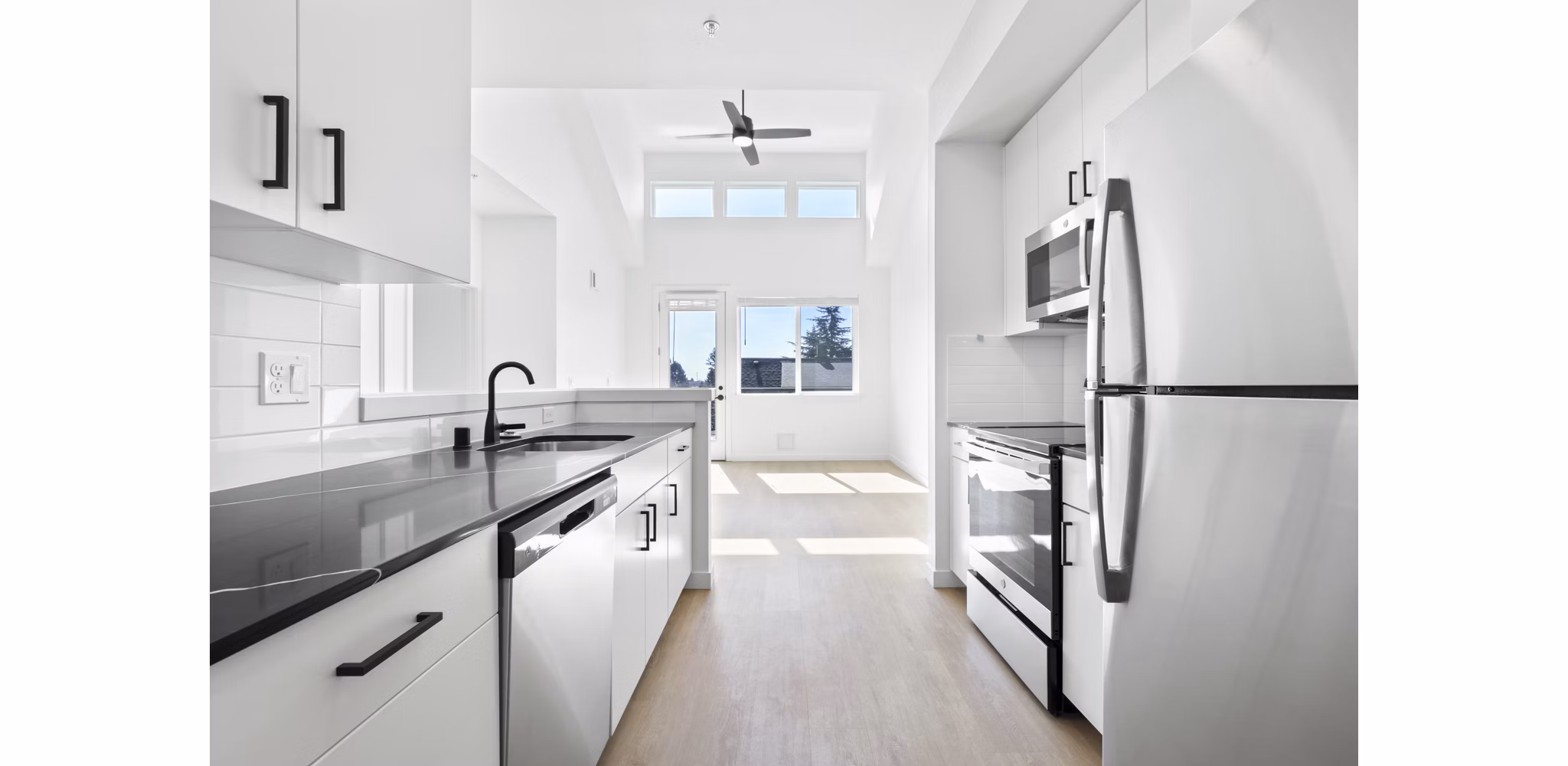 Modern kitchen with stainless steel appliances at Hudson West Apartments