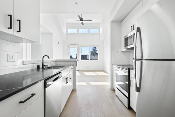 Modern kitchen with stainless steel appliances at Hudson West Apartments