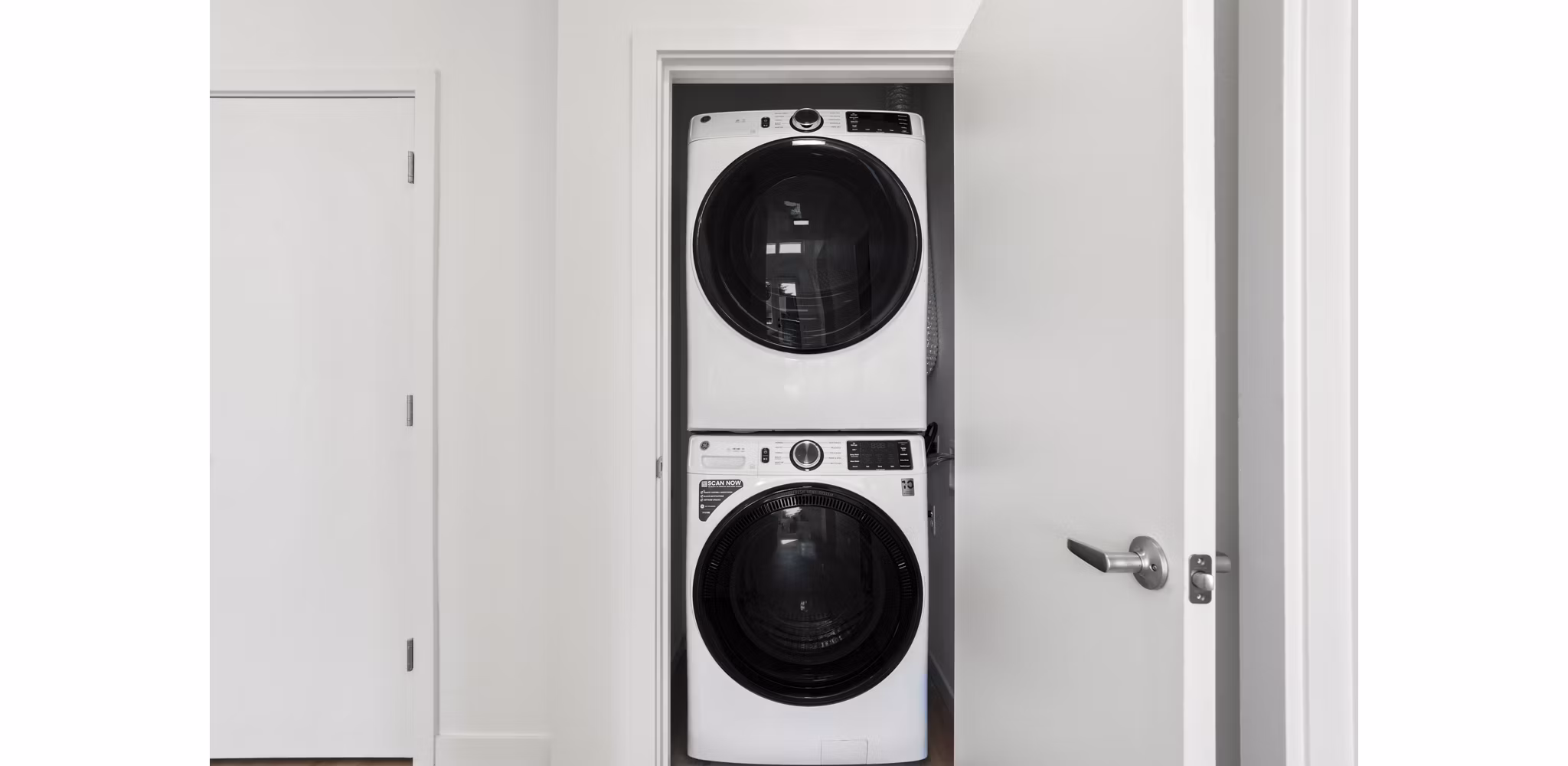 Laundry room featuring modern appliances in Drexler Townhomes at Holbrook Farms