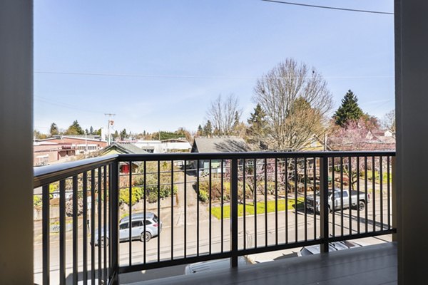 Hudson West Apartments: Contemporary patio space with modern seating and greenery, perfect for relaxation and gatherings