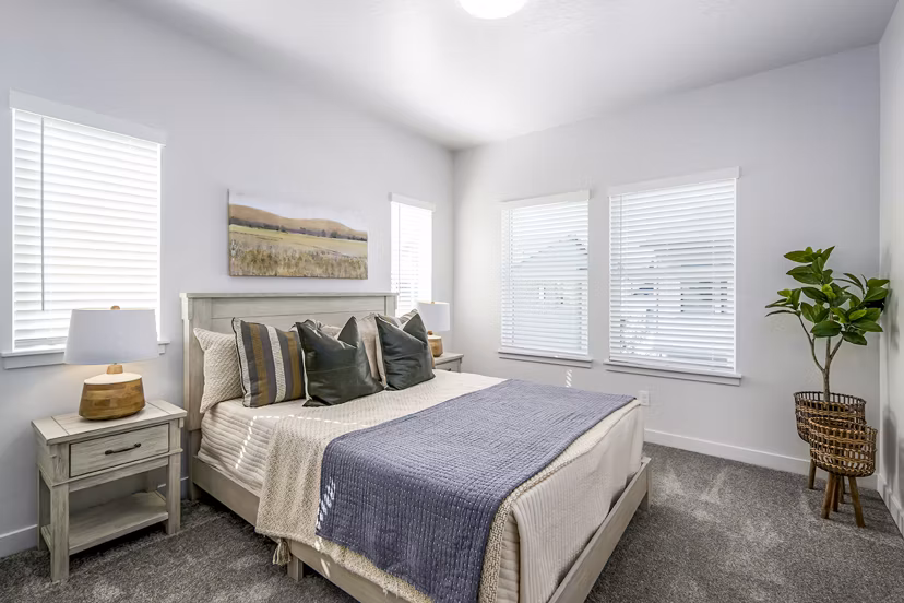 Cozy bedroom with designer accents at Calypso Apartments luxury apartments
