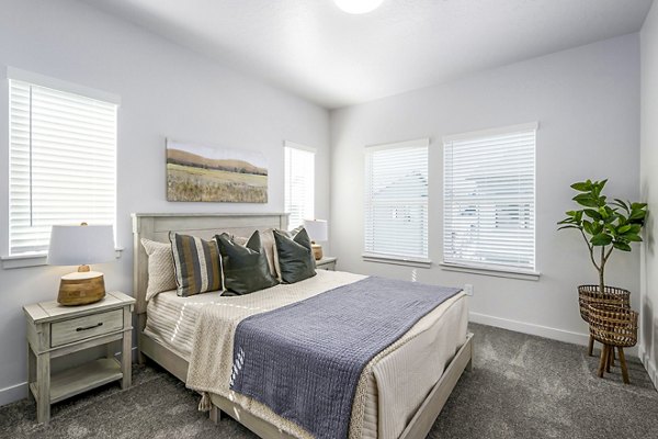 Cozy bedroom with designer accents at Calypso Apartments luxury apartments