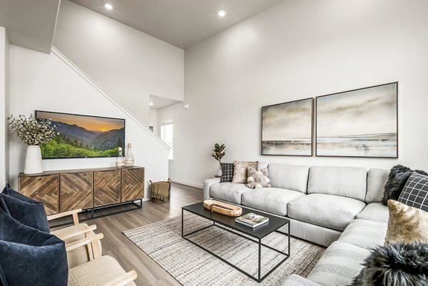 Spacious living room with modern furnishings in Calypso Apartments