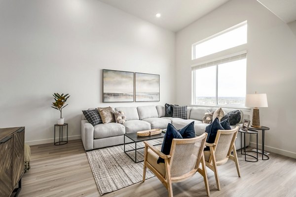 Modern living room with stylish furniture and natural light at Calypso Apartments, offering luxury living in a vibrant community