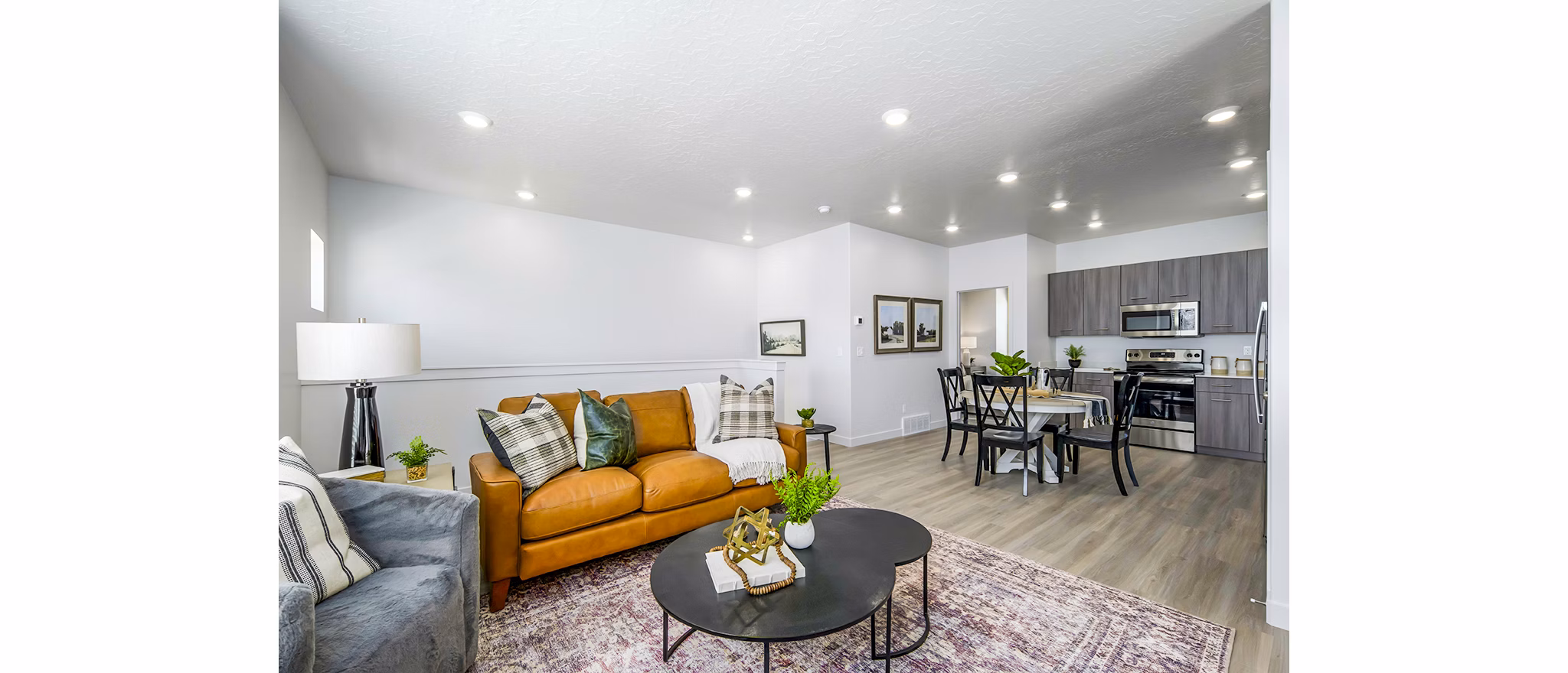 Living room with modern decor and large windows at Calypso Apartments, luxury living spaces for comfort and style