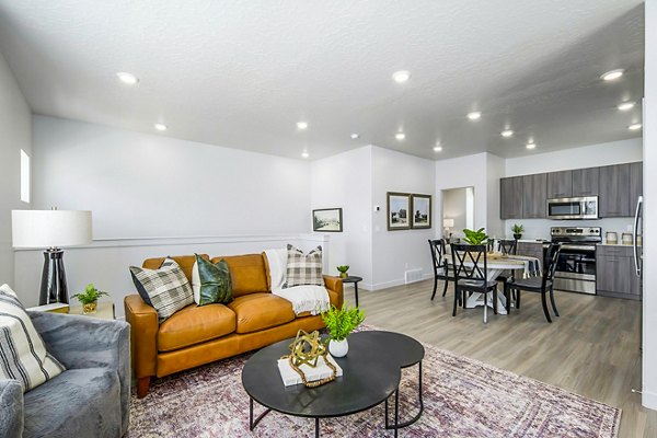 Living room with modern decor and large windows at Calypso Apartments, luxury living spaces for comfort and style