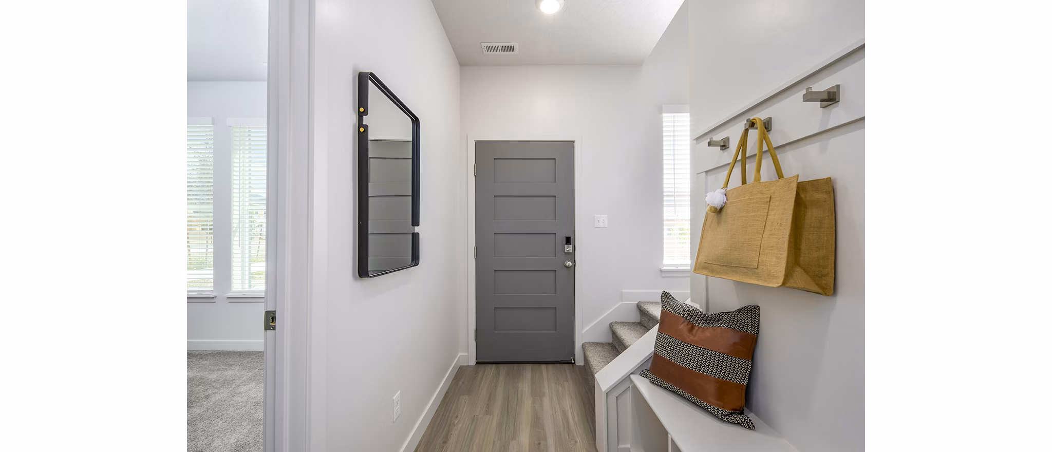 Calypso Apartments: Elegant entry with open stairway leading to a modern living room in luxury community