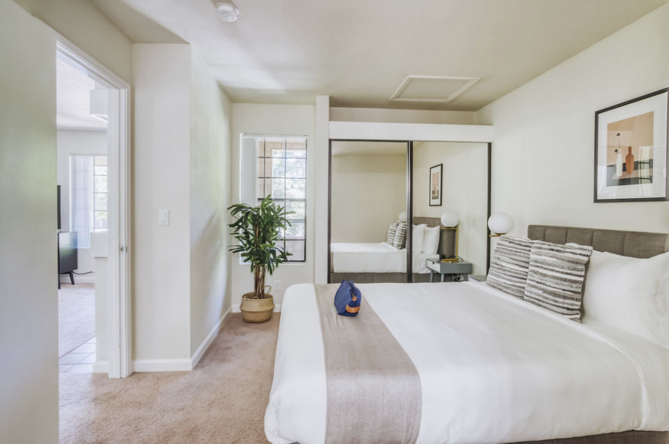 Comfortable bedroom with modern furniture at Ygnacio Village Apartments, ideal for luxury living in a serene setting