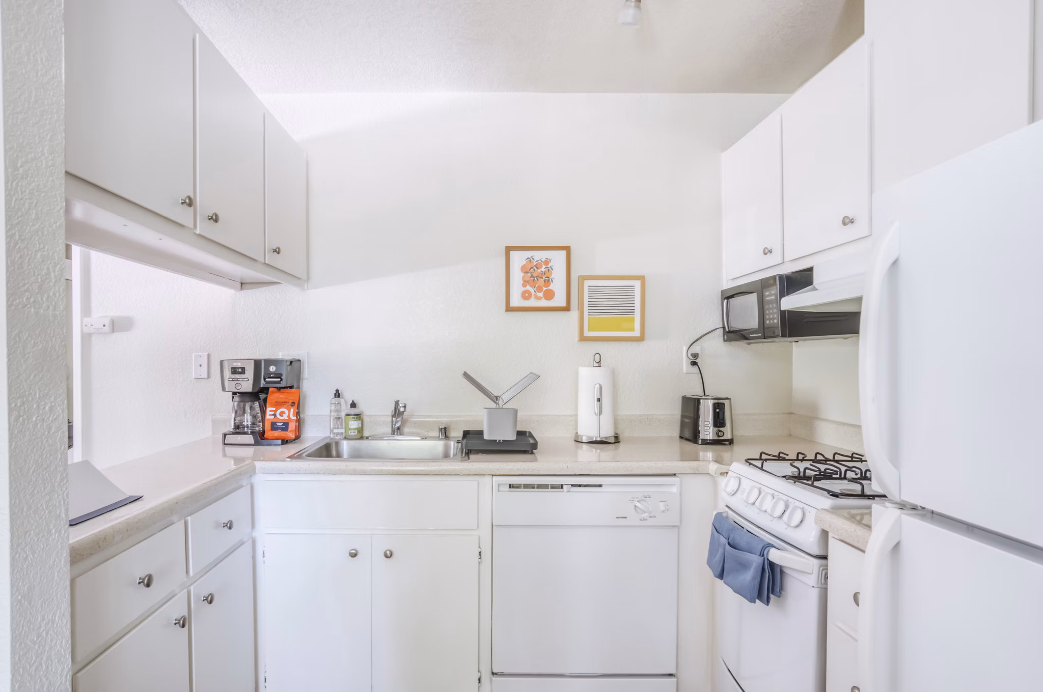 Contemporary kitchen with stainless steel appliances at Ygnacio Village Apartments, ideal for luxury living