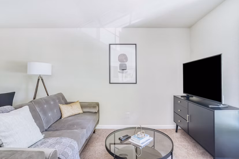 Spacious living room with modern decor at Ygnacio Village Apartments, featuring large windows and ample natural light