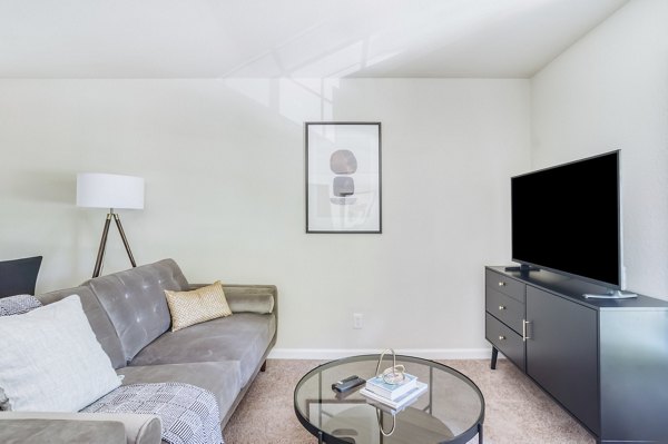 Spacious living room with modern decor at Ygnacio Village Apartments, featuring large windows and ample natural light