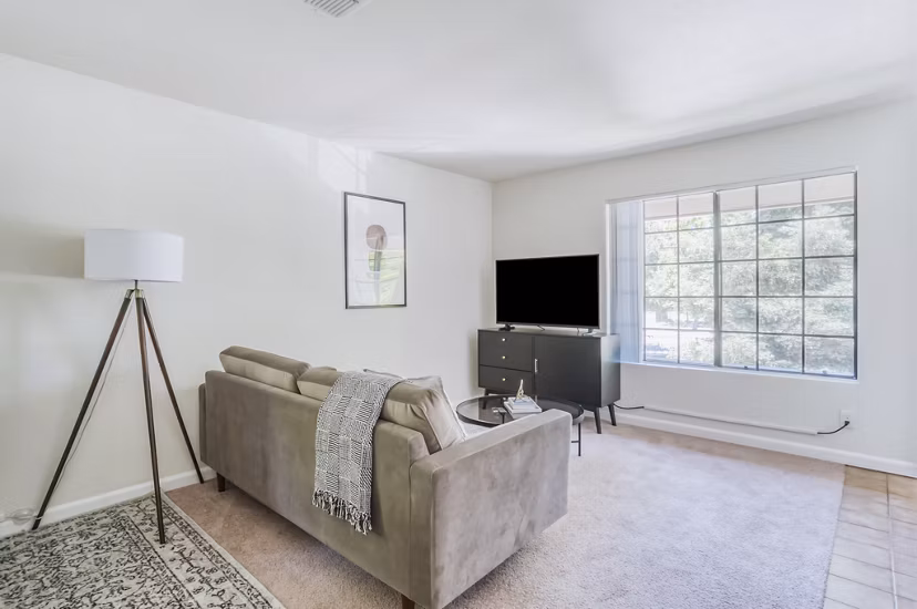 Spacious living area with modern furnishings in Ygnacio Village Apartments, offering comfort and style