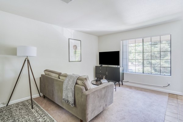 Spacious living area with modern furnishings in Ygnacio Village Apartments, offering comfort and style