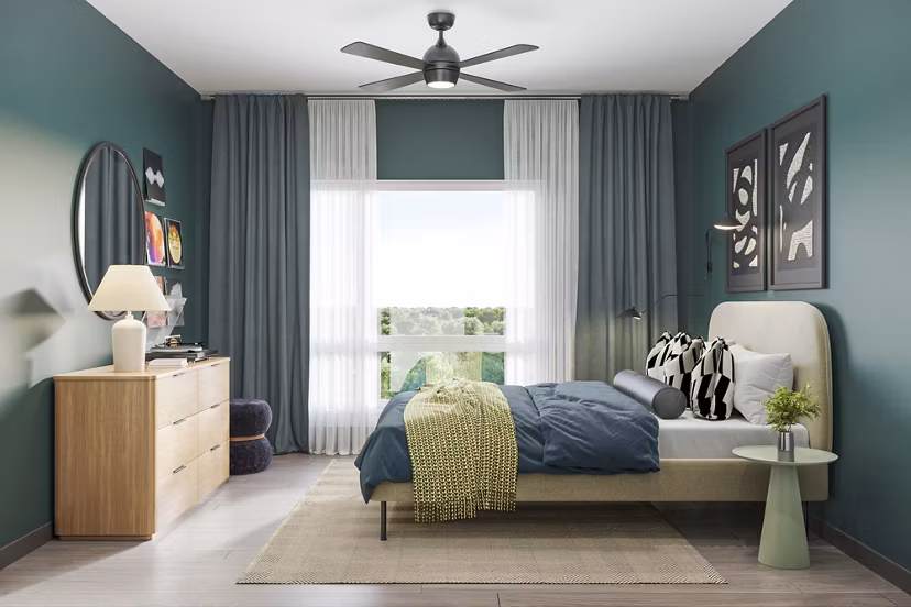 Cozy bedroom with natural light at The Miles Apartments