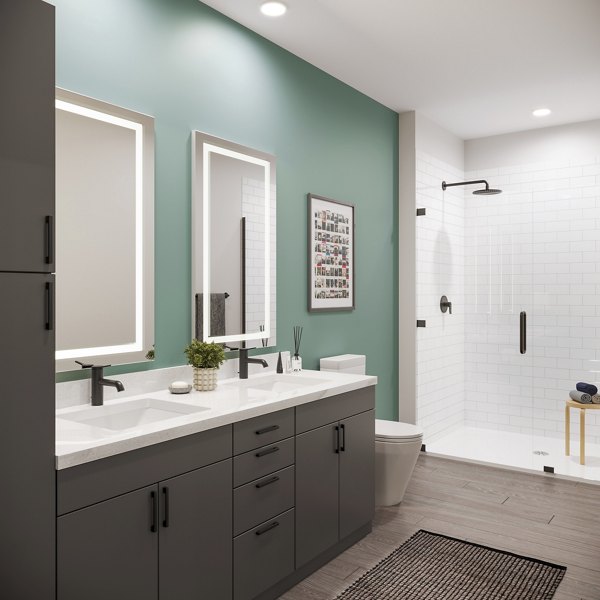 Modern bathroom featuring sleek fixtures and bright lighting at The Miles Apartments