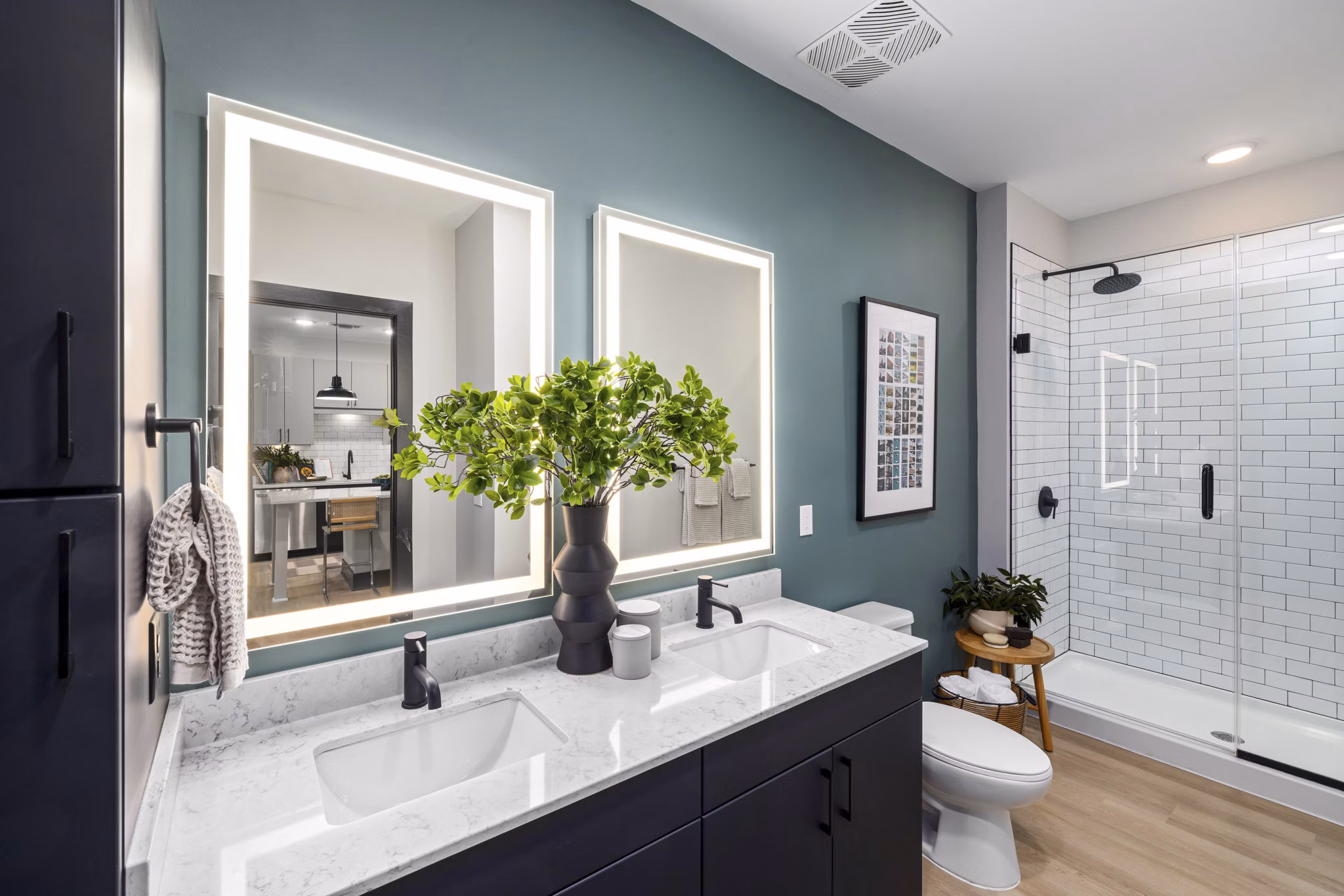 Modern bathroom with sleek fixtures and ample lighting at The Miles Apartments