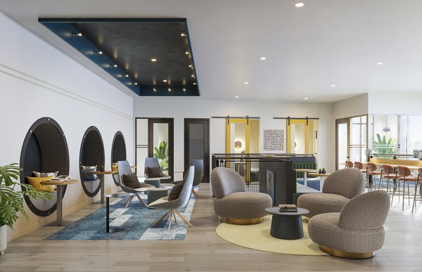 Modern clubhouse with lounge seating and game room at The Miles Apartments in luxury setting