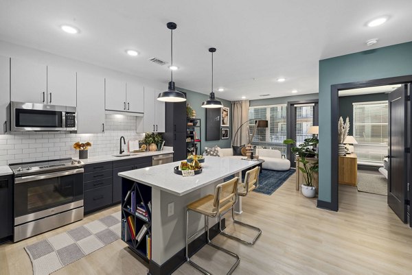 The Miles Apartments: Modern kitchen with stainless steel appliances and sleek countertops in luxury Greystar apartments