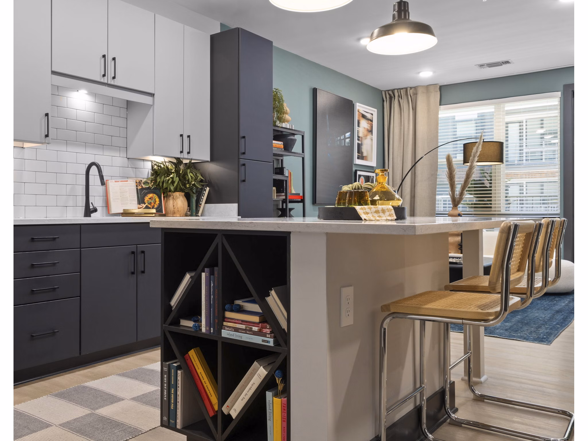 Modern kitchen featuring stainless steel appliances and granite countertops at The Miles Apartments