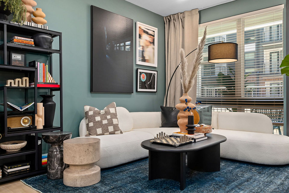 Modern living room with sleek furniture and large windows at The Miles Apartments