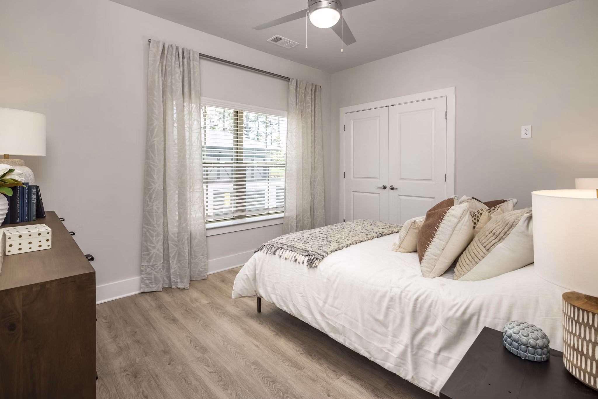 Arcadia at Symphony Park: Modern bedroom with stylish furnishings and large windows in Arcadia luxury apartments, Las Vegas