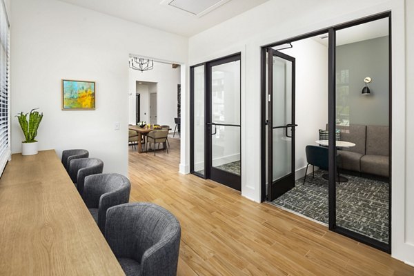 Clubhouse at Arcadia at Symphony Park Apartments: Elegant gathering space featuring modern seating and lighting in a luxury apartment community
