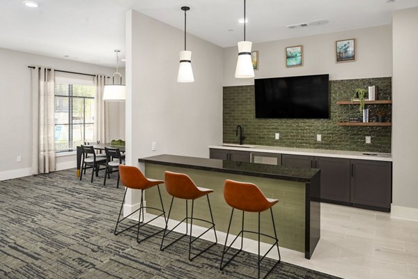 Dining room featuring elegant chandeliers and modern furnishings in Arcadia at Symphony Park Apartments