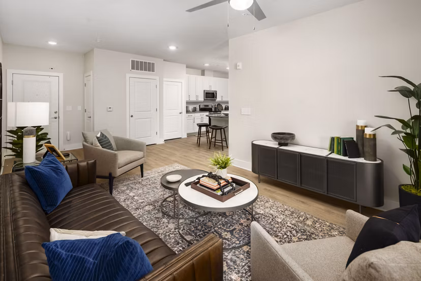 Elegant living room with modern decor and large windows at Arcadia at Symphony Park Apartments