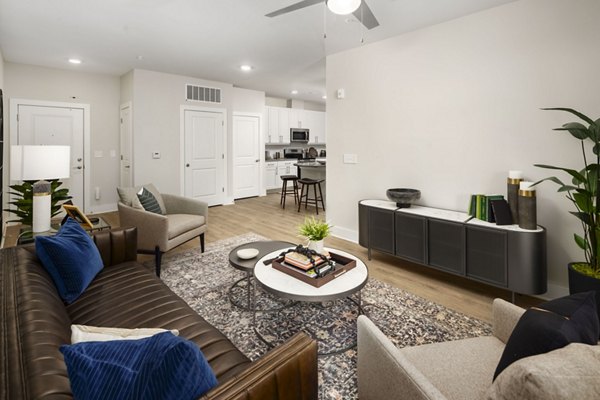 Elegant living room with modern decor and large windows at Arcadia at Symphony Park Apartments