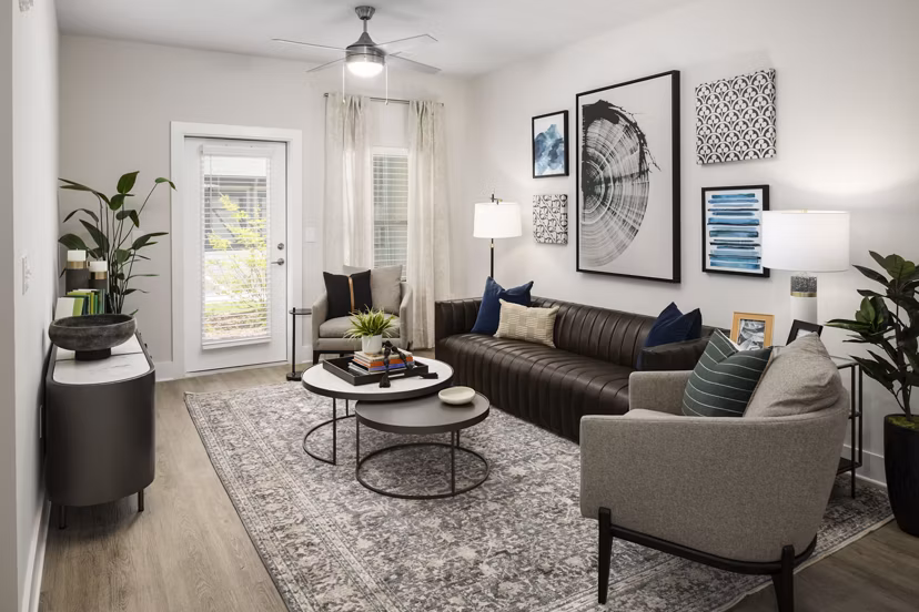 Spacious living room featuring contemporary design and large windows at Arcadia at Symphony Park Apartments