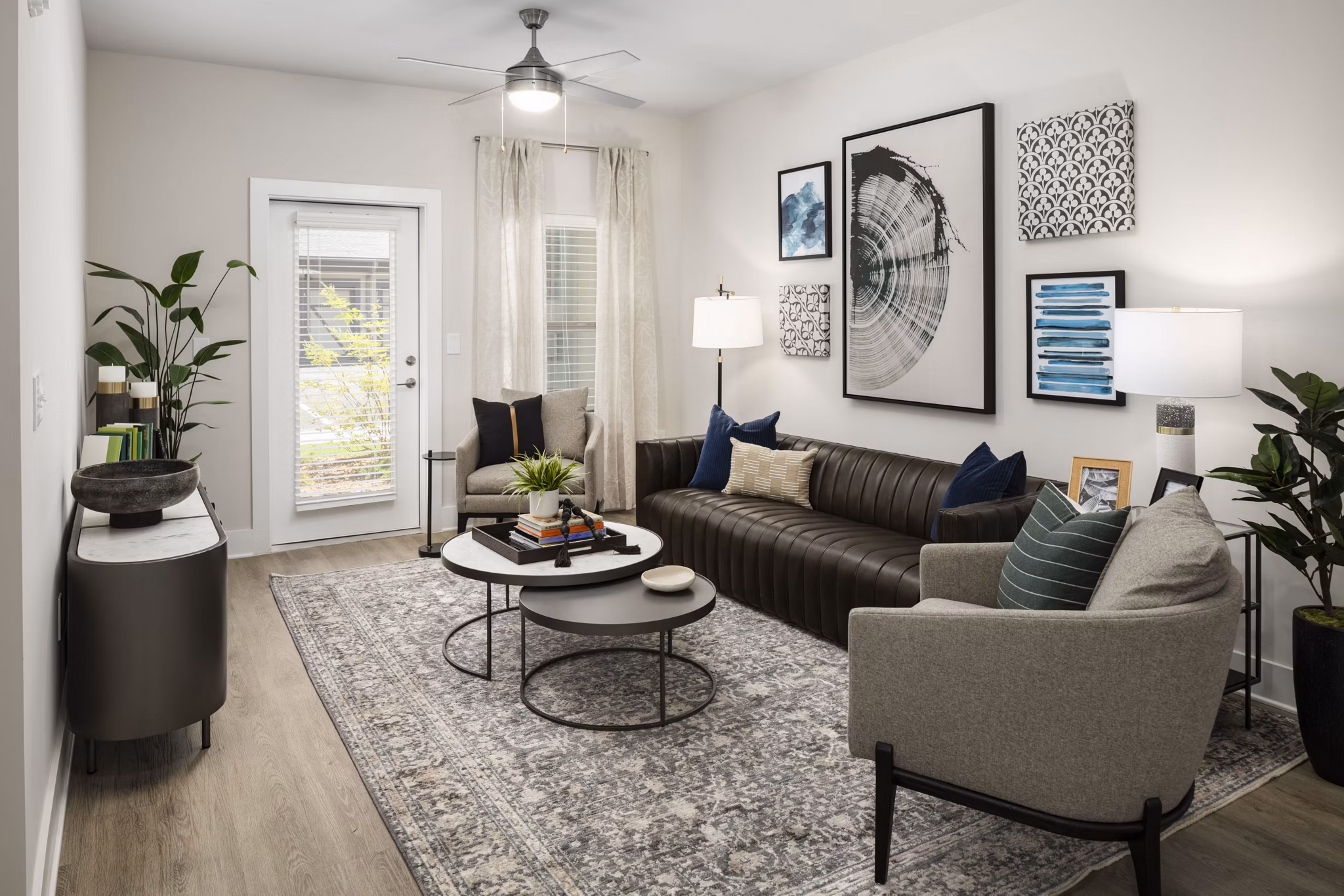 Spacious living room featuring contemporary design and large windows at Arcadia at Symphony Park Apartments