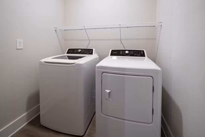 Laundry room with modern appliances at Arcadia at Symphony Park Apartments in Las Vegas