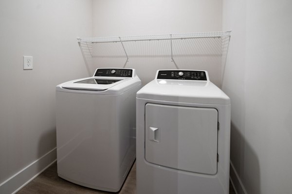 Laundry room with modern appliances at Arcadia at Symphony Park Apartments in Las Vegas