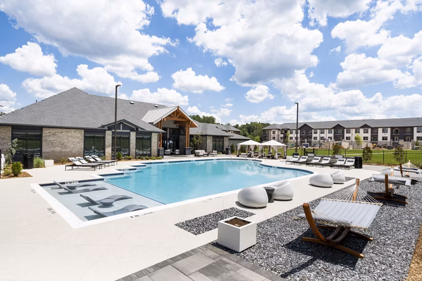 Luxurious pool area with sun loungers at Arcadia at Symphony Park Apartments