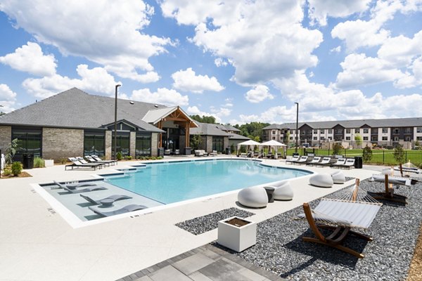 Luxurious pool area with sun loungers at Arcadia at Symphony Park Apartments