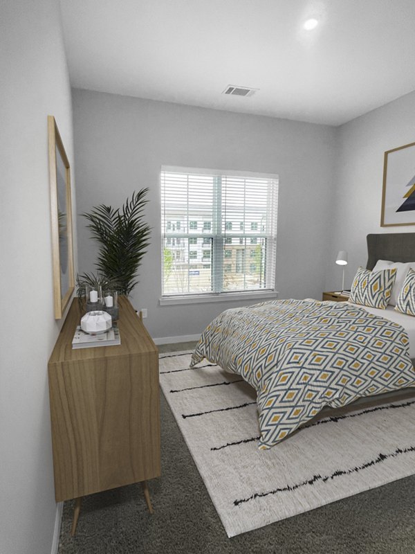 Elegant bedroom with plush bedding and modern decor at Camellia at One Nexton Apartments