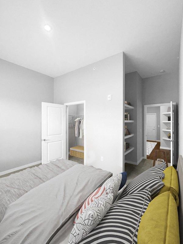 Bedroom featuring elegant decor and large windows at Camellia at One Nexton Apartments