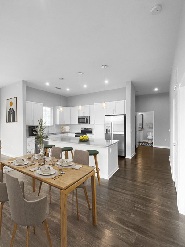 Dining room with elegant lighting and contemporary furniture at Camellia at One Nexton Apartments