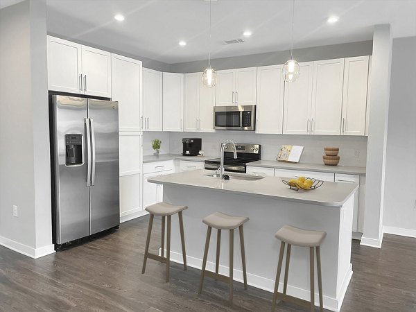 Kitchens showcasing granite countertops and stainless appliances at Camellia at One Nexton luxury apartments