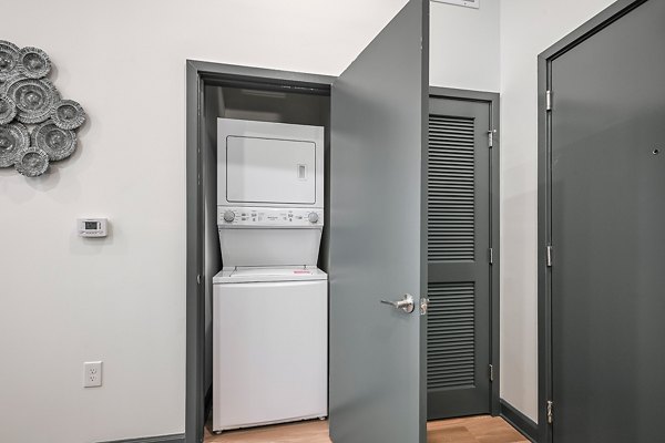 Laundry room with modern facilities at Apollo Apartments, featuring energy-efficient washers and dryers for convenient resident use