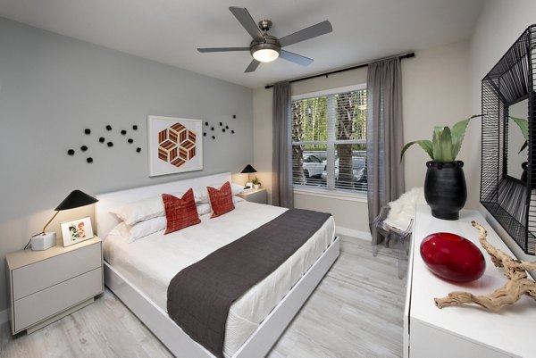 Cozy bedroom with plush bedding and modern decor at SUR Lake Buena Vista Apartments