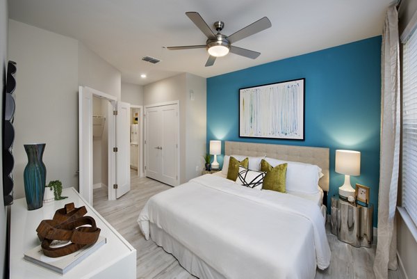 Cozy bedroom with plush bedding and modern decor at SUR Lake Buena Vista Apartments