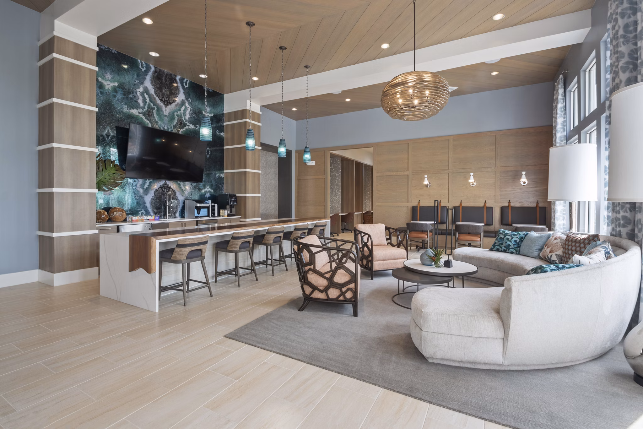 Clubhouse featuring modern decor and seating areas at SUR Lake Buena Vista Apartments, a Greystar community