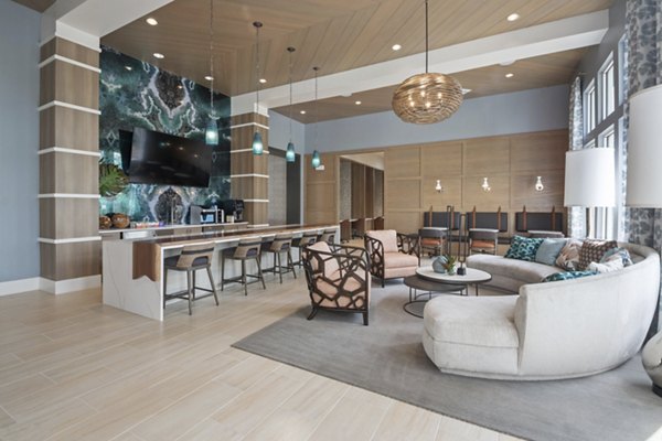 Clubhouse featuring modern decor and seating areas at SUR Lake Buena Vista Apartments, a Greystar community