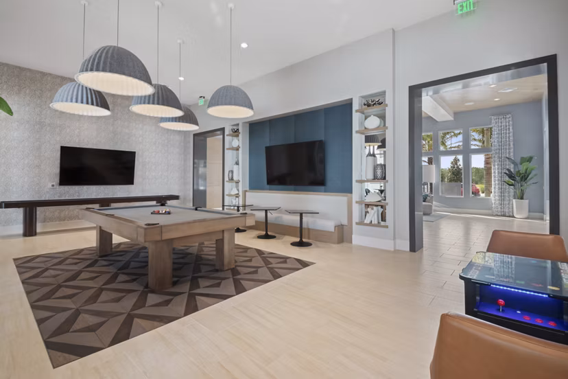 Game room with billiards and arcade games at SUR Lake Buena Vista Apartments