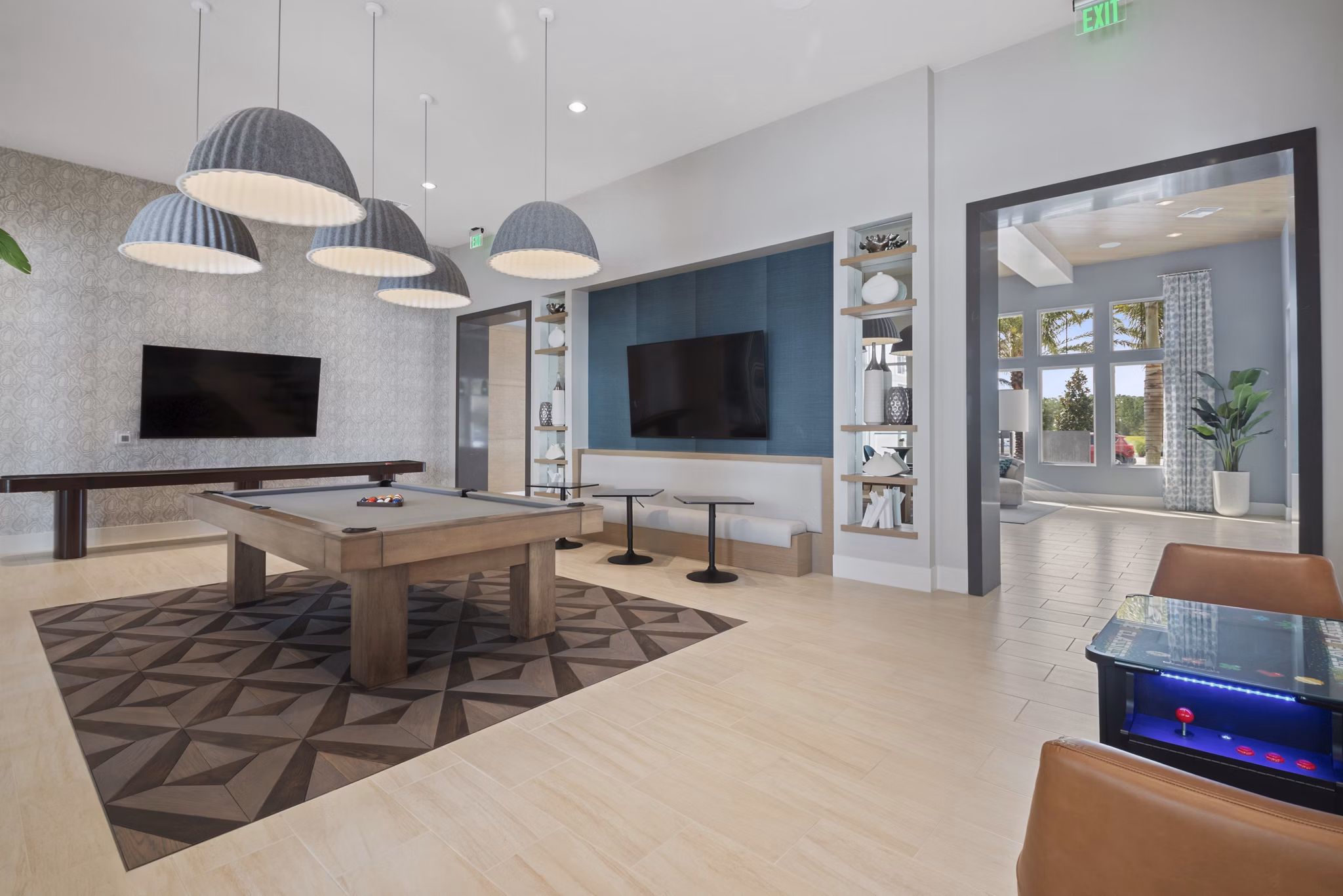 Game room with billiards and arcade games at SUR Lake Buena Vista Apartments
