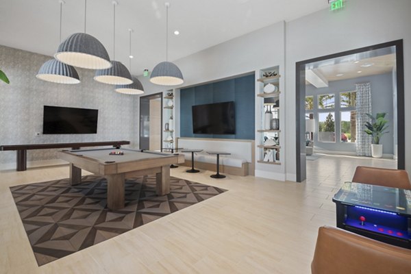 Game room with billiards and arcade games at SUR Lake Buena Vista Apartments
