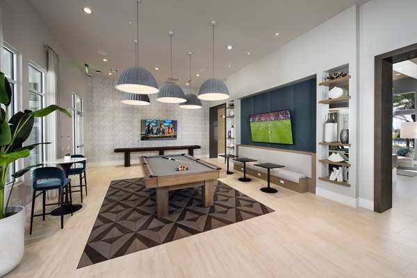 Game room with pool table and arcade games at SUR Lake Buena Vista Apartments